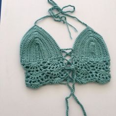 This top will best fit a size xsmall/small. It was made with soft acrylic worsted weight yarn. It ties around the neck as well as behind the back & has one tie criss crossing in the middle of the chest - which can be tied any way & loosens and tightens the top as well. Crochet Yarn Top For The Beach, Crochet Yarn Top For Beach, Beach Crochet Top With Crochet Trim, Fitted Crochet Cotton Top For Beach, Fitted Crochet Top In Cotton Yarn For Beach, Fitted Cotton Crochet Top For Beach, Fitted Cotton Yarn Crochet Top For Beach, Fitted Bohemian Crochet Cotton Top, Beach Crochet Top With Open Knit