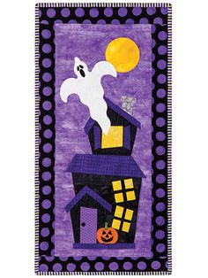 a purple and black wall hanging with a ghost on top of a house next to a full moon