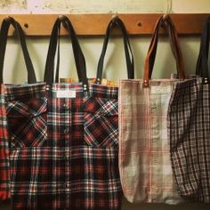 three plaid bags hanging on a wall next to each other