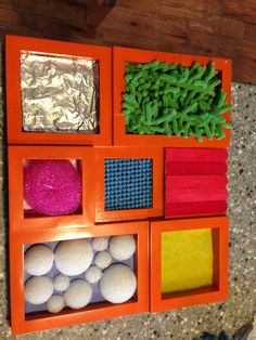 an orange box filled with lots of different colored balls