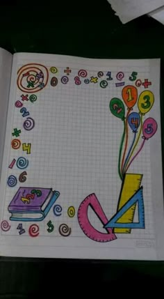 an open notebook with colorful drawings and numbers on the pages, along with some balloons