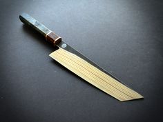 a knife with a wooden handle on a black surface