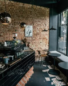 a brick wall in a restaurant with tables and chairs