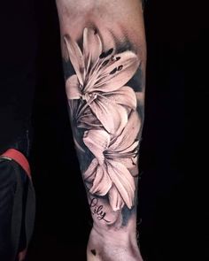 a woman's arm with flowers on it