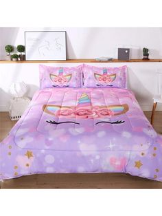 a bed with a pink comforter and pillows