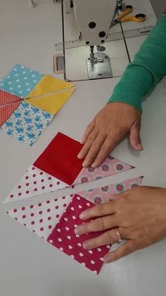 a woman is working on some quilting material