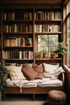 a living room filled with lots of books and furniture