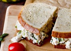 a sandwich cut in half sitting on top of a cutting board