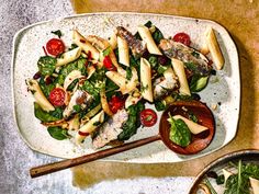 a white plate topped with pasta and veggies