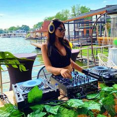 a woman with headphones is mixing music