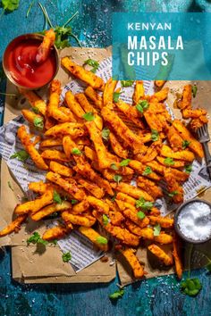 Masala chips on brown paper with tomato sauce and a small pot of salt. Masala Chips, Oven Chips, Vegetable Curry Recipes, Kenyan Food, Masala Fries, Potato Slices, Masala Sauce, Garlic And Ginger