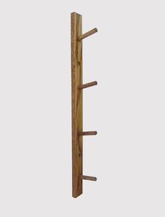 a wooden coat rack with five coats hanging from it's sides and three pegs on each side