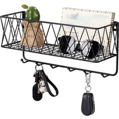 a black metal shelf with sunglasses and keys hanging from it