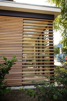 a modern house with wooden slats on the side