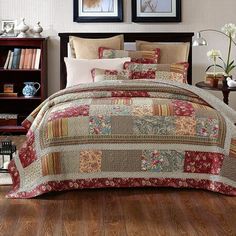 a bed covered in lots of different types of quilts and pillow shampoos