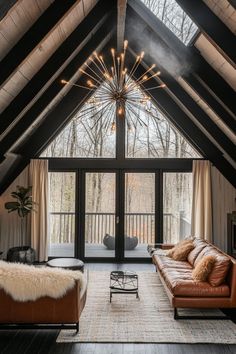 a living room with two couches and a large window in the ceiling is lit by lights