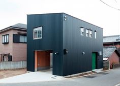 an industrial building with two garages on the street