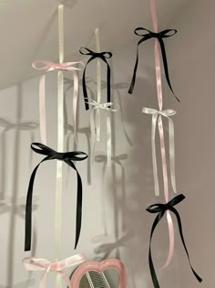 several ribbons hanging from the ceiling in front of a mirror with a hair dryer on it