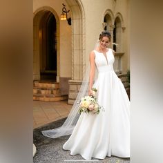 a woman in a white wedding dress holding a bouquet