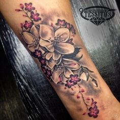 a woman's arm with flowers on it