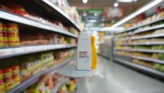 a bottle of mustard sitting on top of a shelf in a grocery store