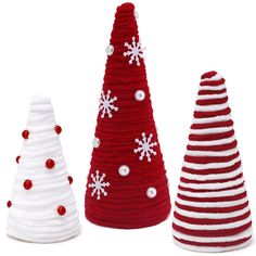 three knitted christmas trees with snowflakes on the top, one red and one white