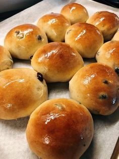 rolls with blueberry toppings sitting on a baking sheet