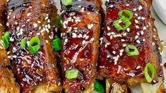 ribs covered in bbq sauce and garnished with green onions