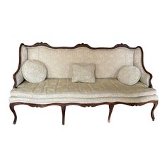 an old fashioned couch with pillows on it's back and arm rests against a white background