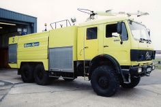 a large yellow truck parked in front of a building