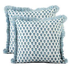 two blue and white pillows with ruffled edges