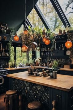 a kitchen filled with lots of plants and hanging lights above the counter top next to an oven