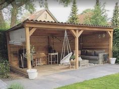 an outdoor living area with wooden walls and roof