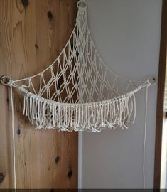 there is a white macrame hanging on the wall