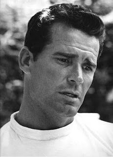 a black and white photo of a man wearing a polo shirt