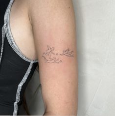 a woman with a small tattoo on her arm