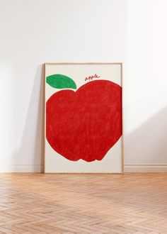 an apple is shown on the wall next to a wooden floor