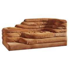 a brown couch sitting on top of a white floor