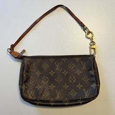 Authentic LOUIS VUITTON Pochette Accessories Brown Monogram Handbag. Louis Vuitton Vintage Monogram Pochette. Strap needs repair by a leather specialist or replacement but overall condition of the actual bag is gently used, minimal wearing for its age. Small white mark on front as seen in picture. Louis Vuitton Pochette Accessories, Pochette Accessories, Louis Vuitton Vintage, Monogram Handbag, Vintage Monogram, Louis Vuitton Pochette, Vintage Louis Vuitton, White Mark, Authentic Louis Vuitton