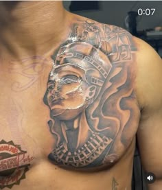 a man with tattoos on his chest has a tattoo design on it's chest