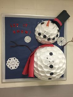 a snowman made out of toilet paper is hanging on the wall