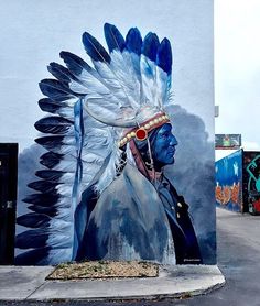 a painting of a native american chief on the side of a building