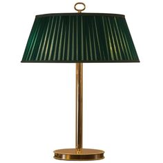 a green lamp sitting on top of a table