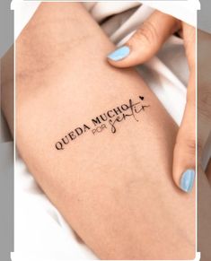 a woman's leg with the words queda muncha on it and a tattoo