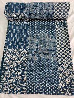 two pieces of blue and white fabric sitting on top of each other