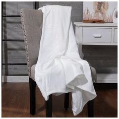 a white blanket sitting on top of a chair