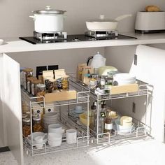 an organized kitchen with pots and pans on the shelves