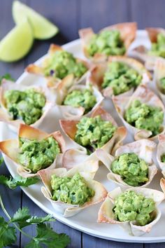 small appetizers with guacamole in them on a plate