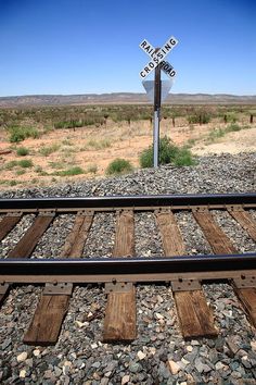 a railroad crossing sign in the middle of nowhere