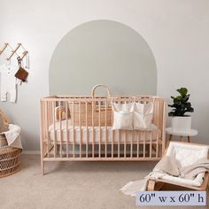 a baby's room with a crib, rocking chair and wall hangings